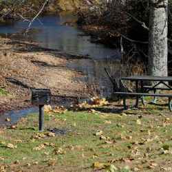 Picnio area next to Garrison Creek. More picnic tables are located under the pavillion.