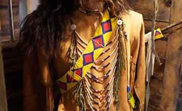 This display includes elements of authentic Native American clothing and regalia.